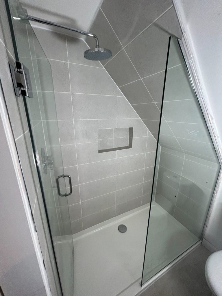 Shower room installation with custom glass shower screen